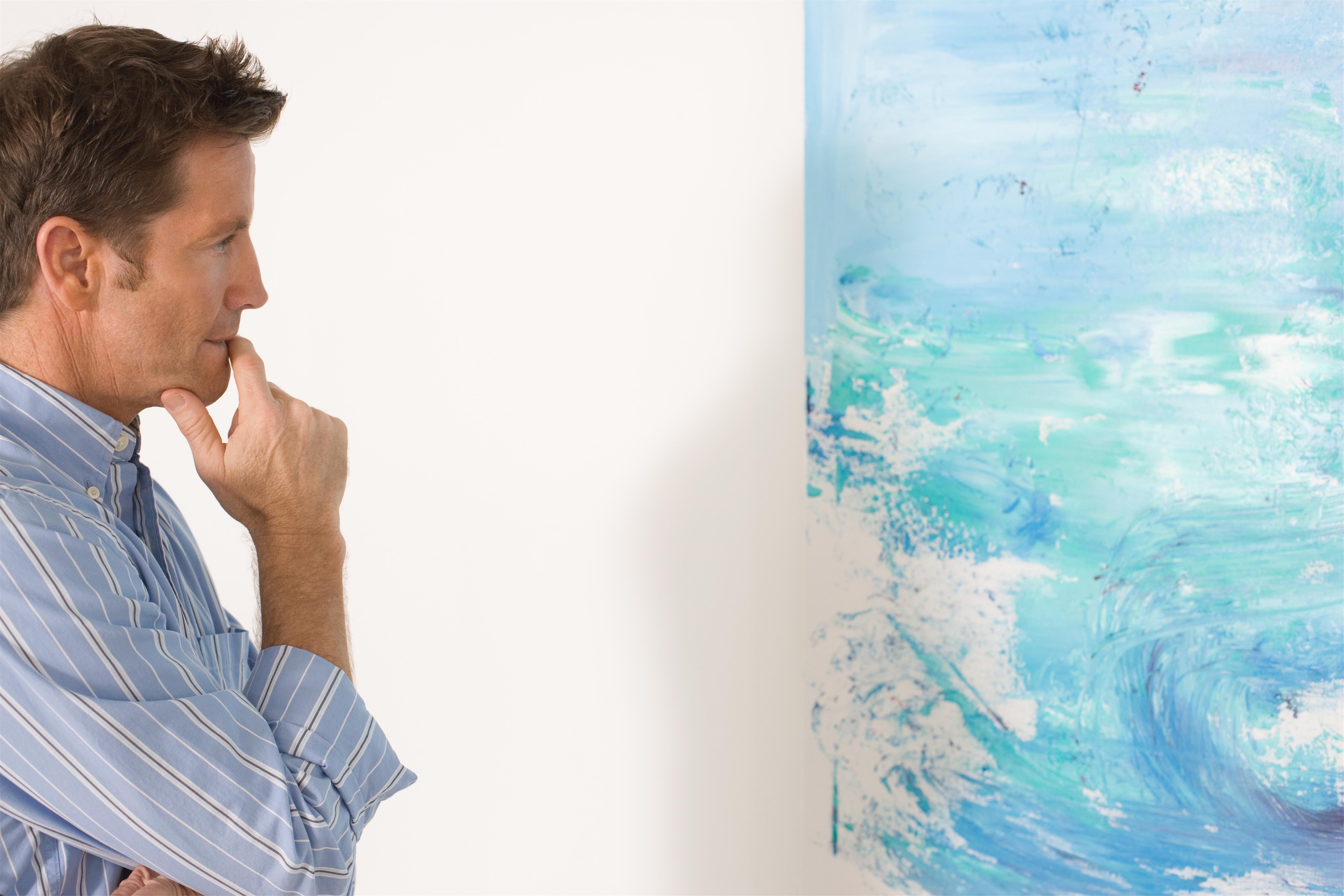 Man contemplating paintings in gallery 3